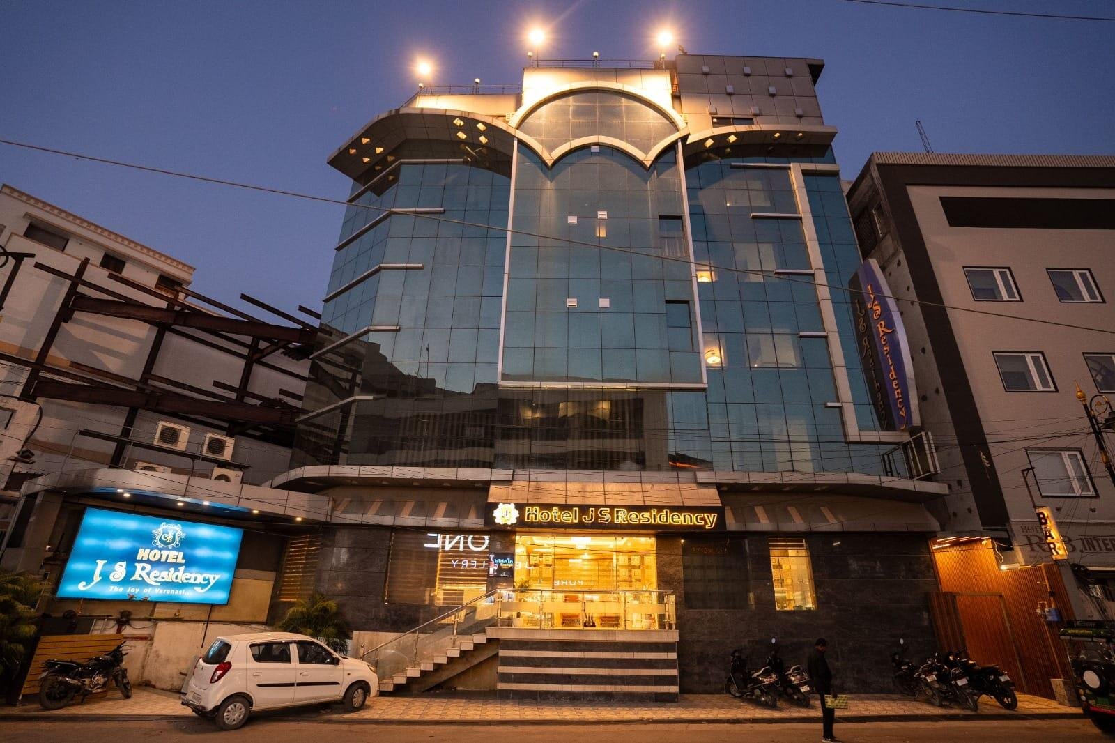 Hotel J S Residency glass facade at dusk, Bhelupur, Varanasi